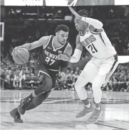  ?? ISAIAH J. DOWNING/USA TODAY SPORTS ?? Suns forward Richaun Holmes (21) guards the Nuggets’ Jamal Murray on Saturday in Denver.