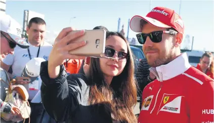  ?? Picture: AFP ?? SMILE PLEASE. Ferrari driver Sebastian Vettel poses for a selfie with a fan in the paddock at the Sochi Autodrom circuit ahead of this weekend’s Formula One Russian Grand Prix.