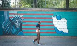  ??  ?? A man walks past an anti-US mural in Tehran in this file picture taken on Oct 13, 2017.