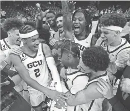  ?? DARRYL WEBB ?? Grand Canyon University players mob teammate Jovan Blacksher Jr. after he was named MVP during their game against San Francisco in the Jerry Colangelo Classic on Dec. 18.