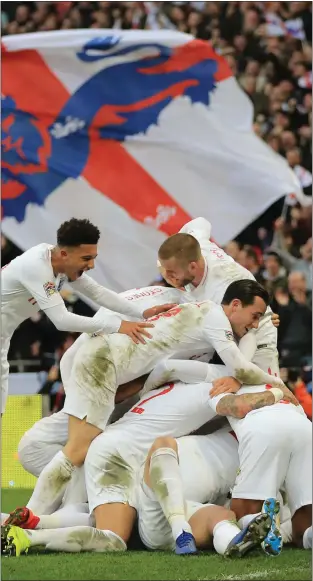  ??  ?? England players mob Harry Kane after the Three Lions skipper netted a strike to snatch victory over Croatia