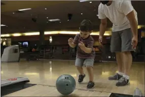  ?? VINCENT OSUNA PHOTO ?? Jojo Sempsrott, 3, bowls during during a soft opening held Saturday at StrikeZone IV in El Centro.