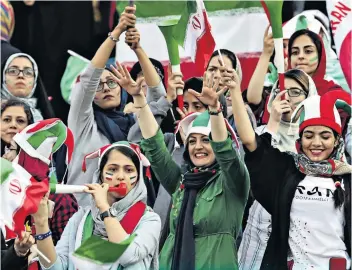  ??  ?? Ban dropped: Delighted Iranian women enjoy the opportunit­y to see the country’s national team in action against Cambodia yesterday