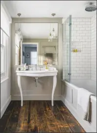  ??  ?? EN SUITE Wood-effect tiles bring a warming, rustic touch to this period-style bathroom. Xylem dark porcelain floor tiles, from £36sq m, Mandarin Stone. White metro wall tiles, £19.50sq m, Topps Tiles