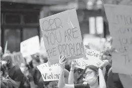  ?? RICARDO RAMIREZ BUXEDA/ORLANDO SENTINEL ?? Protesters carry signs in the Orlando Black Out March on June 6.