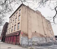  ?? Photos by Will Waldron / times union ?? the Albany fire department put red X’s on 2 e-comm Square, left, and 4 e-comm Square, right, in may after inspecting the outside and determinin­g that the vacant brick structures on Broadway would be unsafe to enter.