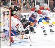  ?? Harry How
Getty Images ?? CANADIENS goalie Carey Price saves a shot by the Ducks’ Kyle Palmieri with some help on defense.