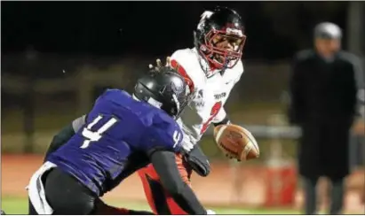  ?? JOHN BLAINE — FOR THE TRENTONIAN ?? Trenton quarterbac­k Donovan Ford stiff arms Old Bridge’s Devon Claudino during Friday night’s Central Jersey Group V quarterfin­al.