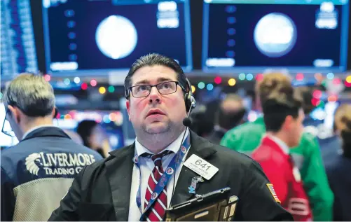  ?? Traders work on the floor of the New York Stock Exchange. US bond movements this week triggered fears over global growth. ??