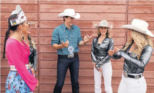  ??  ?? Sidle up Justin Trudeau, the Canadian prime minister, talks with the Calgary Stampede Queen, Princesses and Indian Princess during the Calgary Stampede in Alberta. The event is an annual rodeo, exhibition and festival held in the city every July.