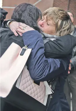  ?? STAFF PHOTO BY JOHN WILCOX ?? RELIEF: Mary Rizzo, right, mother of murder victim Jonathan Rizzo, gets a hug from the forewoman following the sentencing of serial killer Gary Sampson yesterday in court.