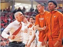  ?? BRAD TOLLEFSON/ASSOCIATED PRESS ?? Texas coach Shaka Smart celebrates with his team during the second half of Saturday’s game against Texas Tech in Lubbock. The Longhorns climbed from No. 71 in the NET in late January to No. 58.