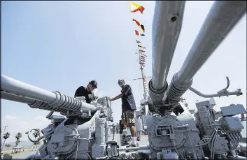  ?? KAREN WARREN/HOUSTON CHRONICLE VIA AP ?? Dr. Kerry Crooks, left, and Dewayne Davis examine the destroyer USS Stewart at Seawolf Park. The Stewart and the submarine USS Cavalla have been restored and are becoming a major tourist attraction.