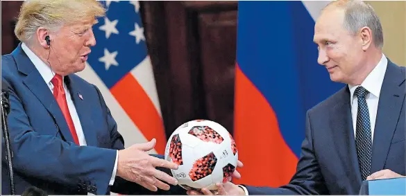  ??  ?? Mr Putin offers Mr Trump a football from the World Cup in front of the press. He then throws it to his wife Melania, who is later pictured, left, with the ball