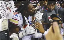  ?? Associated Press ?? Birmingham Stallions running back Bo Scarbrough kisses the trophy after the Stallions defeated the Philadelph­ia Stars 33-30 in the USFL championsh­ip game, Sunday, in Canton, Ohio.