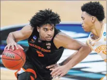  ?? Paul Sancya The Associated Press ?? Oregon State guard Ethan Thompson tries to drive against Tennessee guard Jaden Springer in the second half of the Beavers’ 70-56 win Friday at Bankers Life Fieldhouse.