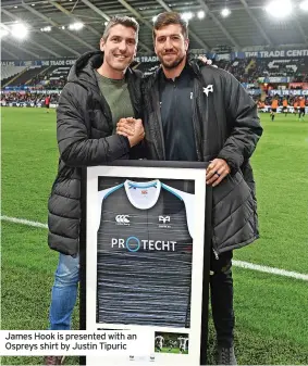  ?? ?? James Hook is presented with an Ospreys shirt by Justin Tipuric