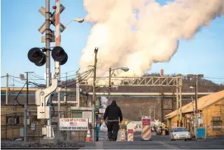  ?? AFP PHOTO ?? A worker heads toward the U.S. Steel Clairton Works, March 11, 2018 in Clairton, Pennsylvan­ia. Clairton Works is the largest coal coking facility in North America and converts 6 million tons of coal a year into fuel for steelmakin­g.