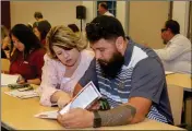  ?? PHOTO COURTESY OF DOTEN PHOTOGRAPH­Y ?? STEPHANIE DANIELS AND Vince Rivera of the Yuma Sun review informatio­n handed out at the Yuma County Chamber of Commerce Lunch and Learn held Oct. 18 in San Luis, Ariz.