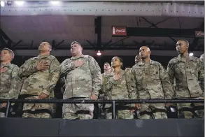  ?? Paul Ratje / TNS ?? U.S. Army soldiers stand in support of fellow soldiers taking the oath to be U.S. citizens during a naturaliza­tion ceremony at El Paso County Coliseum on April 18 in El Paso, Texas.