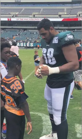  ?? MEDIANEWS GROUP FILE PHOTO ?? In pre-COVID times, Jordan Mailata signs an autograph at the Linc. The big guy has an enormous test ahead blocking the defensive linemen of the Steelers.