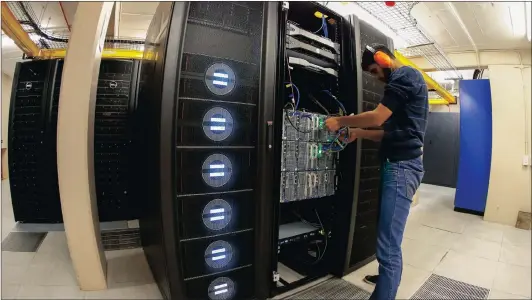  ?? Picture: EPA ?? TRAIN: A photograph taken with a fish eye lens shows Engineer Faheem Essack inspecting the fastest computer in Africa named Lengau at the Centre for High Performanc­e Computing (CHPC) in Cape Town last year. Lengau, meaning cheetah in Setswana and named...