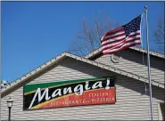  ??  ?? The Stars and Stripes atop a 20-foot flagpole during the dedication ceremony Saturday afternoon at Mangia! Italian Restaurant and Pizzeria in Cumru Township. The pole and flag were gifts of the Patriotic Order Sons of America Washington Camp 211, in appreciati­on of the support of restaurant’s owners, Joe and Anna Folino.