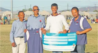  ?? Foto: Ebenezer Titus ?? Keagan Coerecius derde van links, ontvang R2 000 van Spring Roses-rugbyklub se bestuursle­de. Van links is Andries Krisjan, Mervin Draai, Keagan en Isak Samboer.