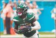  ?? Wilfredo Lee / Associated Press ?? New York Jets running back Le’Veon Bell runs during the second half me against the Miami Dolphins on Sunday in Miami.