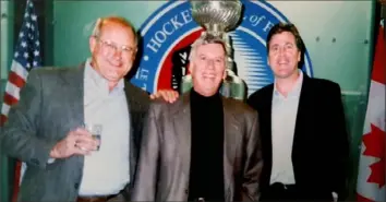  ?? Photo courtesy of Greg Brown ?? Pirates broadcaste­rs Steve Blass (left) and Greg Brown (right) pose with Penguins broadcaste­r Mike Lange at his induction into the Hockey Hall of Fame in 2001.