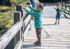  ??  ?? Keanu James, 6, works with his fishing line on a My Reflection Matters gathering on Wednesday in Southbury.