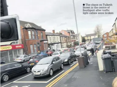  ??  ?? The chaos on Tulketh Street in the centre of Southport after traffic light cables were broken