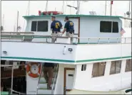  ?? CHRISTIAN MONTERROSA - THE ASSOCIATED PRESS ?? FBI investigat­ors climb aboard the “Vision” a sister vessel to the scuba boat Conception to document its layout and learn more about the deadly pre-dawn fire in Santa Barbara, Calif., Tuesday. A fire raged through the Conception boat carrying recreation­al scuba divers anchored near an island off the Southern California Coast on Monday, leaving multiple people dead. Authoritie­s on Tuesday ended the search for survivors.