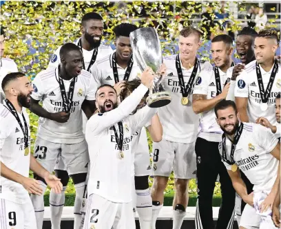  ?? Picture: AFP ?? MORE SILVERWARE. Real Madrid’s Dani Carvajal lifts the Uefa Super Cup surrounded by team-mates after beating Eintracht Frankfurt in Helsinki on Wednesday night.