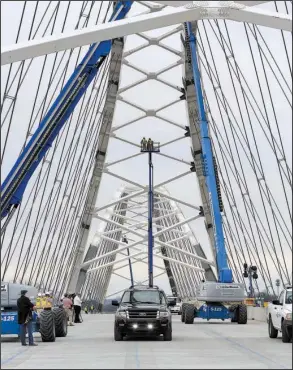  ?? Arkansas Democrat- Gazette/ STATON BREIDENTHA­L ?? Scott Bennett, director of the Arkansas Highway and Transporta­tion Department, takes the ceremonial fi rst drive across the Broadway Bridge over the Arkansas River on Monday afternoon. The bridge now is predicted to open to vehicle traffic next week at...