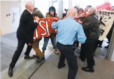  ?? CP PHOTO ?? Security fights to keep protesters from storming a building where Prime Minister Justin Trudeau was scheduled to address a forum on Tuesday in Ottawa.