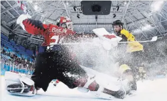  ?? POOL GETTY IMAGES ?? Kevin Poulin makes a save as Germany’s Marcus Kink stands by during Friday’s hockey semifinal.