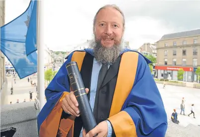  ??  ?? Film director David Mackenzie with his honorary degree in the City Chambers, City Square.