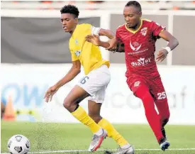  ?? CONCACAF MEDIA ?? Ky-Mani Campbell (left) of Waterhouse FC getting away from Joseph Gomez of Vega Real during the third-place match in the FLOW Concacaf Caribbean Club Championsh­ip held at the Cibao Stadium in Santiago de los Caballeros, Dominican Republic, on Sunday.