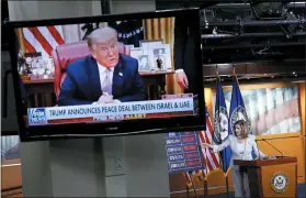  ?? PATRICK SEMANSKY — THE ASSOCIATED PRESS ?? House Speaker Nancy Pelosi of Calif., right, speaks during a news conference on Capitol Hill in Washington on Thursday as a television broadcasts President Donald Trump speaking from the White House.