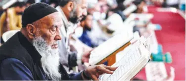  ?? Agence France-presse ?? ↑
An elderly Palestinia­n man reads the Holy Quran at a mosque in the Nuseirat refugee camp in central Gaza Strip on Monday.