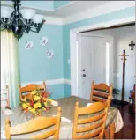  ??  ?? A tray ceiling and a contempora­ry chandelier add elegance to the formal dining room.