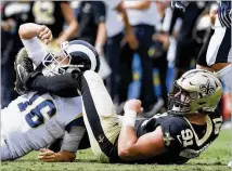  ?? KEVORK DJANSEZIAN / GETTY IMAGES ?? After forcing Rams QB Jared Goff to fumble Sunday, Saints defensive end Trey Hendrickso­n (91) watches a teammate return it for a long touchdown. However, the play was blown dead, and New Orleans was forced to take the ball at its 13.