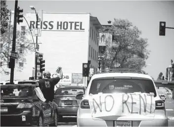  ?? SAM HODGSON U-T FILE ?? Protesters demonstrat­ing from their cars as part of a “Food Not Rent” caravan pass through downtown San Diego in May. The city is encouragin­g residents to apply for a rental relief program that launched last week.