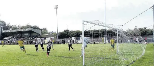  ??  ?? ● Caernarfon Town celebrate another Nathan Craig goal at Flint last weekend. Picture: PAUL EVANS