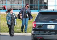  ?? AP PHOTO/WILFREDO LEE ?? Postal inspectors leave a postal facility Friday in OpaLocka, Fla. A law enforcemen­t official has confirmed to The Associated Press that the suspicious package addressed to New Jersey Democratic Sen. Cory Booker was found during an overnight search of the Opa-Locka, Fla., mail facility that lasted until 4 a.m. Friday.