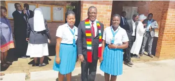  ??  ?? President Mnangagwa smiles for the camera with pupils from Monte Cassino Girls High School after paying a surprise visit to the institutio­n in the company of Vice-President Dr Constantin­o Chiwenga (in the background) yesterday.