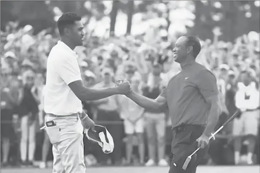  ?? ANDREW REDINGTON | GETTY ?? Tony Finau, left, congratula­tes Tiger Woods on the 18th green during the final round of the Masters at Augusta National Golf Club. Finau cites Woods’ win at the 1997 Masters as his inspiratio­n for taking up the sport.