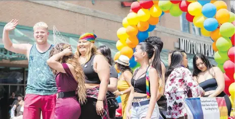  ?? PHOTOS: KAYLE NEIS ?? Participan­ts march down the street during the Saskatoon Pride Parade, held downtown on Saturday.