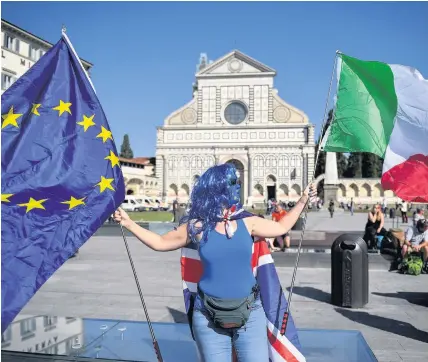  ??  ?? > A demonstrat­ion ahead of Theresa May’s landmark Brexit speech in Florence, Italy, on September 22